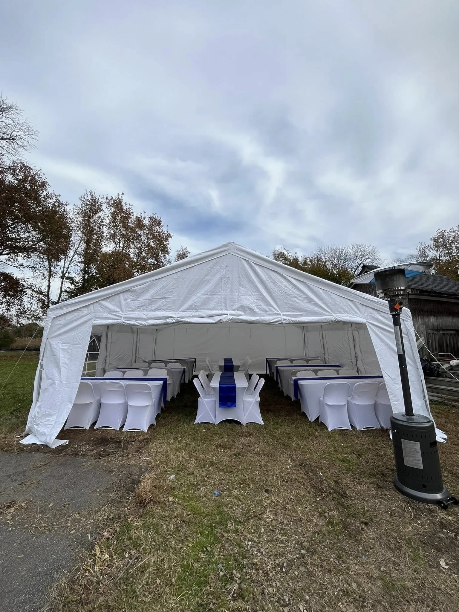 Royal blue table with blue chair sashes for outdoor event setup