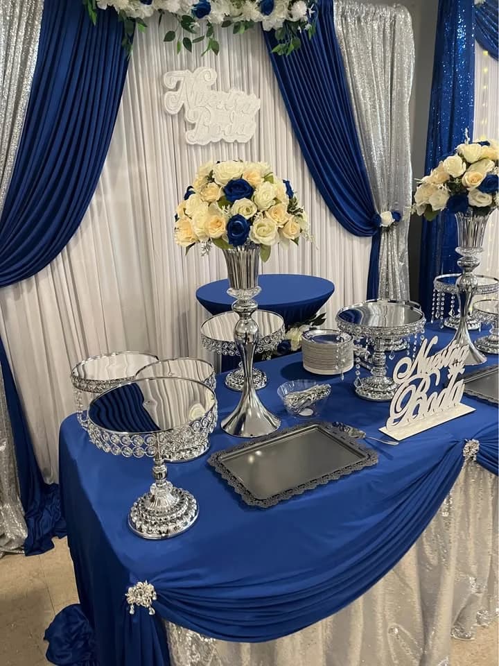 Royal blue and silver sweetheart table setup for a wedding reception by Rosy's Rental